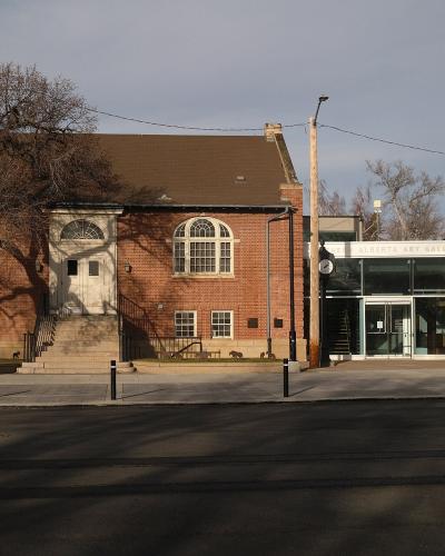 A red brick building with a classical entrance and a modern glass extension, featuring a sign above the entrance that reads "SOUTHERN ALBERTA ART GALLERY".
