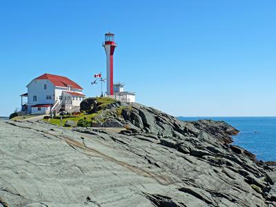 Cape Forchu Lighthouse on the rocky coast near Yarmouth, Nova Scotia