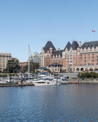 The Fairmont Empress hotel and the Inner Harbour marina in Victoria, British Columbia, under a clear sky