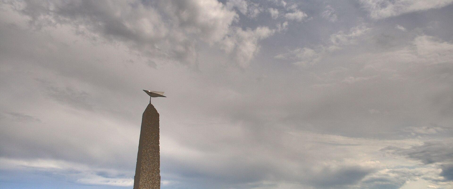 The Bush Pilots Monument obelisk on its rock above Yellowknife Bay