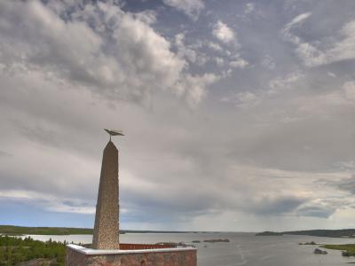The Bush Pilots Monument obelisk on its rock above Yellowknife Bay