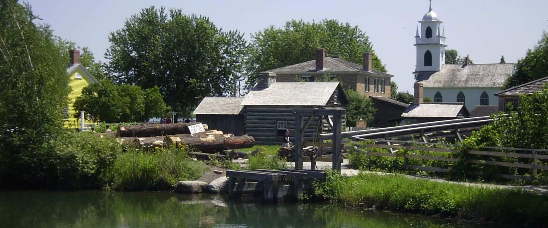 Heritage buildings by the water at Upper Canada Village on the St. Lawrence