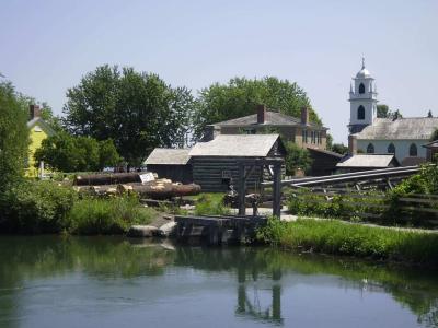 Heritage buildings by the water at Upper Canada Village on the St. Lawrence