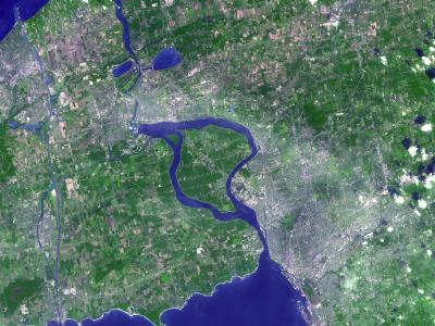 A satellite image showing the Niagara River flowing south from Lake Erie into Lake Ontario, with the distinct loop of the river and surrounding agricultural and urban areas visible.