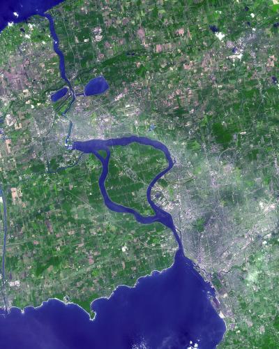 A satellite image showing the Niagara River flowing south from Lake Erie into Lake Ontario, with the distinct loop of the river and surrounding agricultural and urban areas visible.