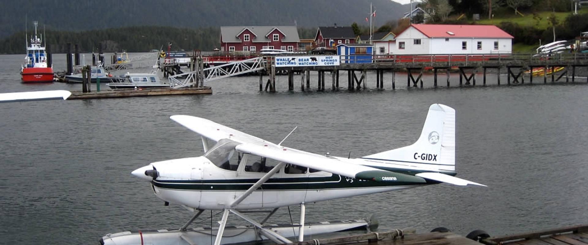 Floatplane at the dock on Tofino Inlet with the Tofino waterfront behind