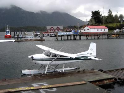 Floatplane at the dock on Tofino Inlet with the Tofino waterfront behind