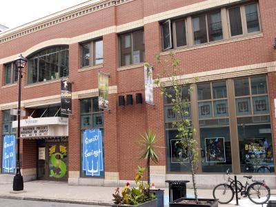 A red brick building facade featuring a theatre marquee with "Neptune" and "Fountain Hall" signage, along with posters for "Willpower Presents Broadway on Argyle".