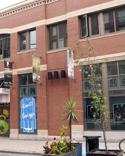 A red brick building facade featuring a theatre marquee with "Neptune" and "Fountain Hall" signage, along with posters for "Willpower Presents Broadway on Argyle".