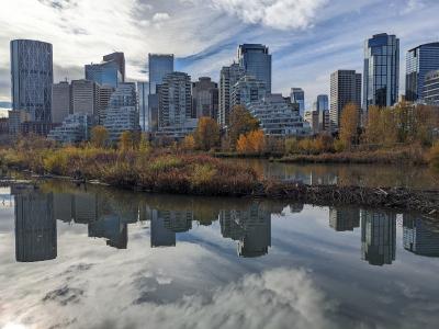 The Calgary skyline reflected in the Bow River in autumn