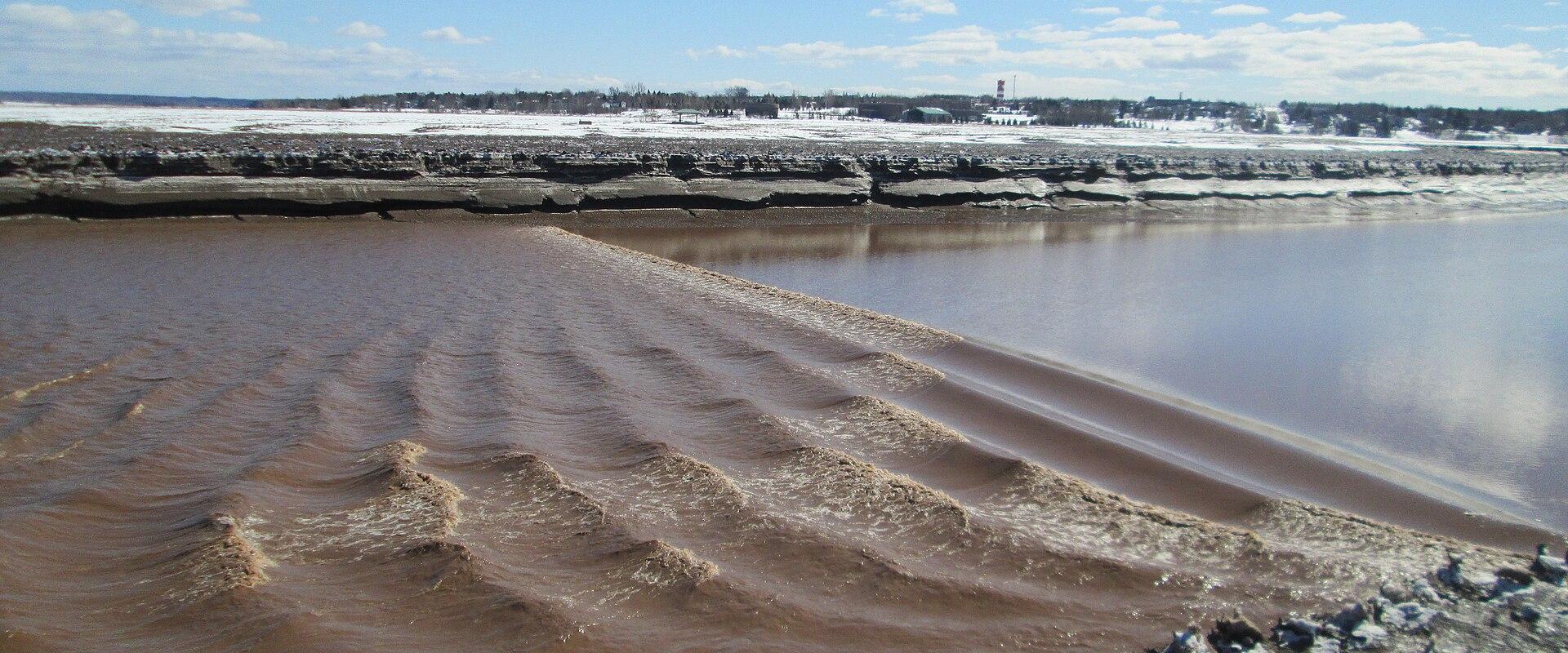 The tidal bore rolling up the Petitcodiac River at Moncton