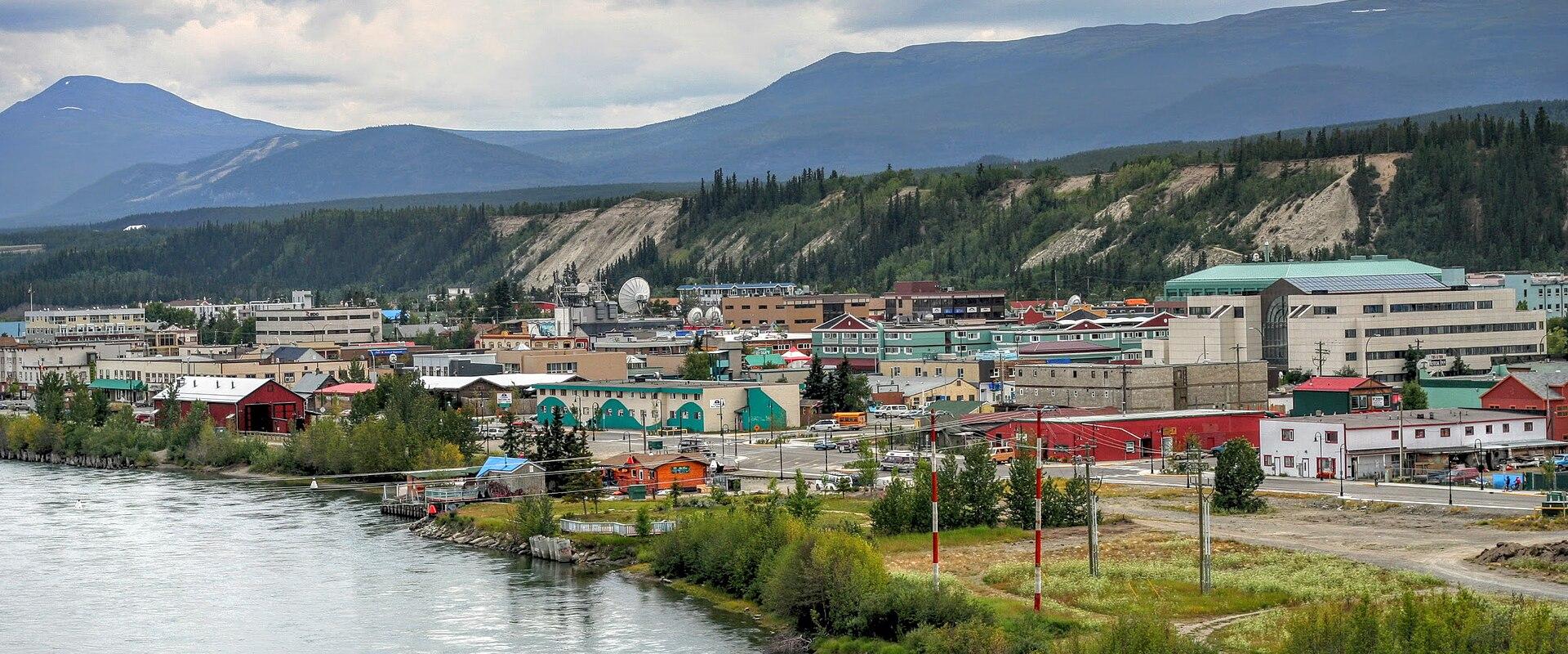 The Yukon River flowing past Whitehorse beneath the hills