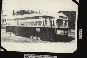 A black and white photograph of a vintage streetcar on tracks, with archival labels identifying it as a "Toronto Transportation Comm." car that was formerly part of the "Cleveland Railways" and "Ex. Louisville Railways Co."