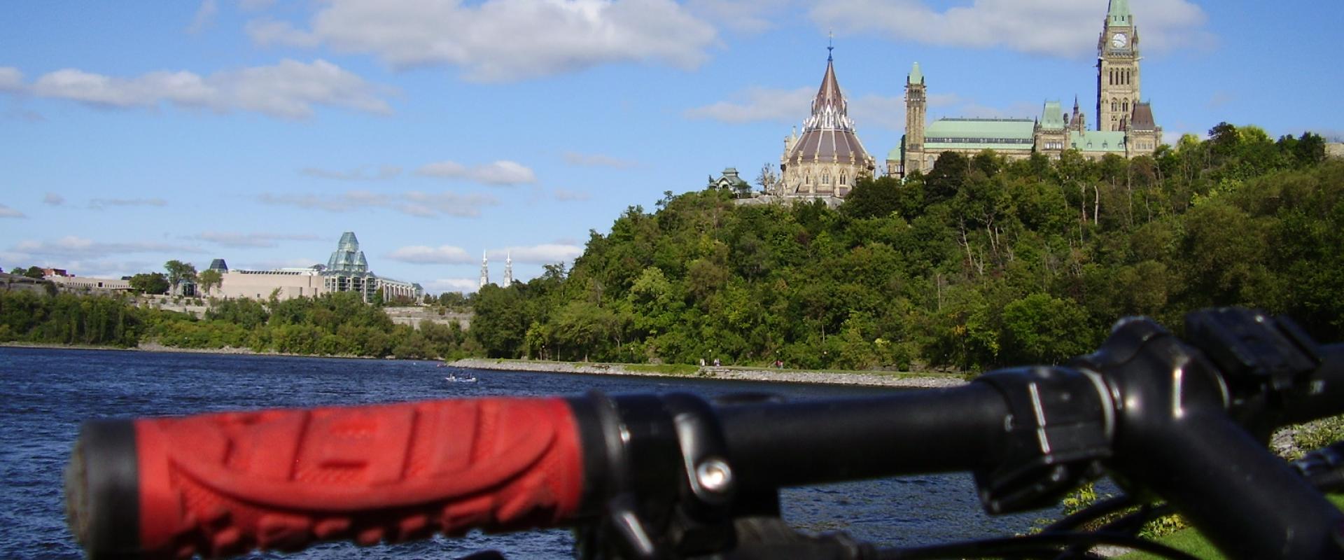 Parliament Hill seen across the Ottawa River from the riverside pathway