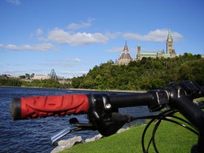 Parliament Hill seen across the Ottawa River from the riverside pathway